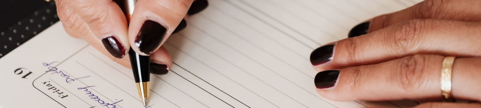 Adult writing a to-do list to manage tasks and stay organised, representing ADHD support and strategies for managing forgetfulness and object permanence.