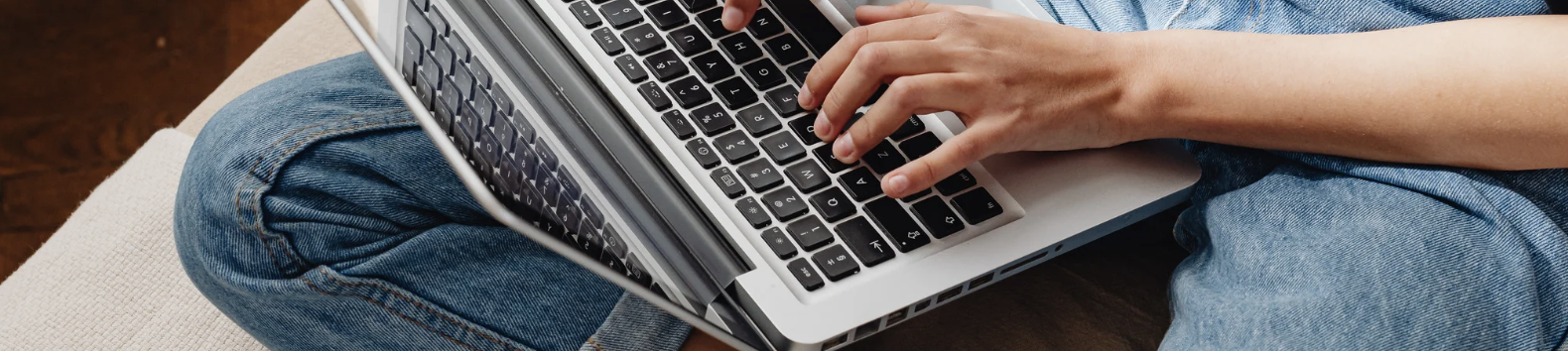 Banner showing a woman on a sofa using a laptop to find low-cost therapy options online